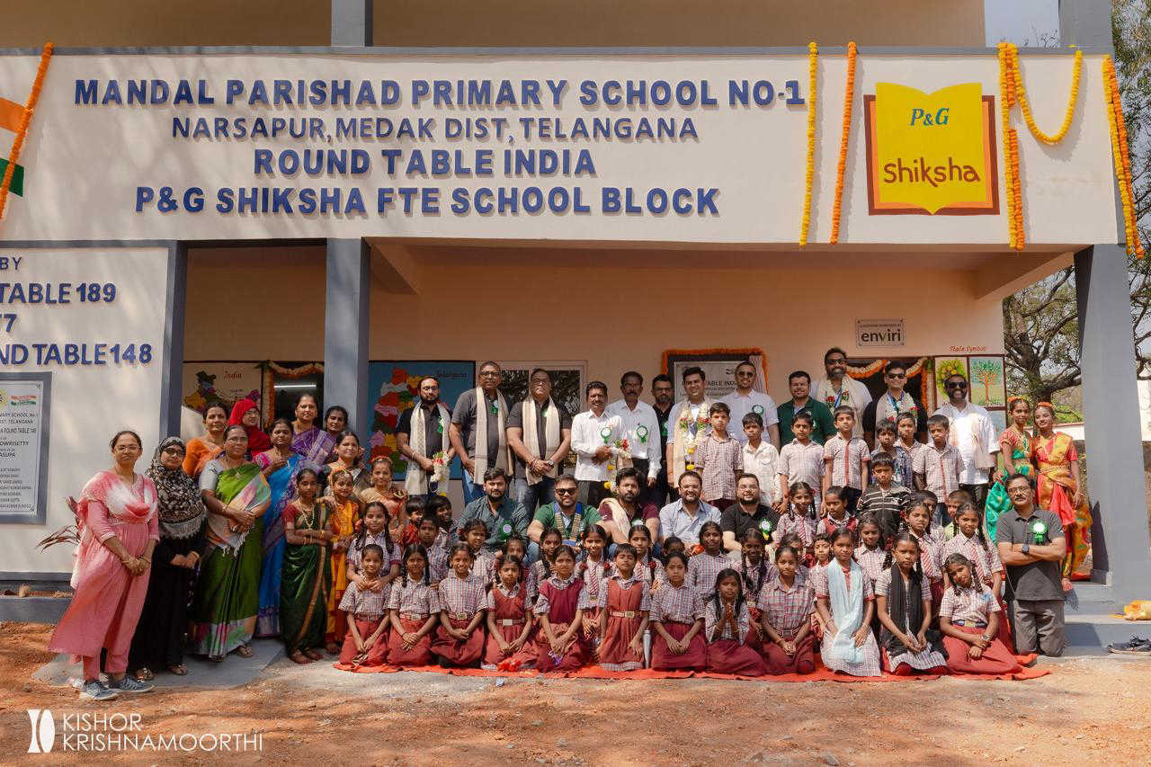 Tablers, teachers and students in front of the new school block at Narsapur